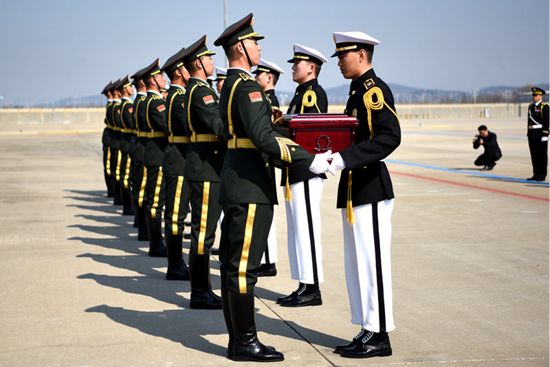 4월 3일, 한국 인천국제공항에서 한국군(오른쪽) 의장대가 중국군 의장대에게 중국군 의장대에게 유해 봉안함을 전달하고 있다. [촬영: 샤쉐(夏雪)]