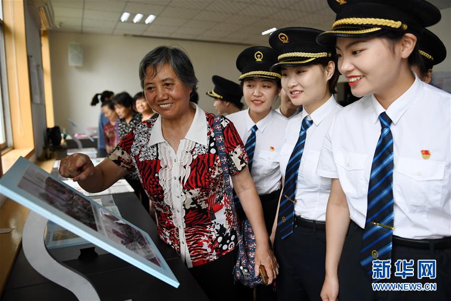 7월 2일 중국 1세대 여성 전기 기관차 기관사 가오쿤푸(高琨璞•왼쪽 1번째)가 바오지(寶雞) 기관차 수리소에서 학생들과 교류를 하고 있다. [사진 출처: 신화망]