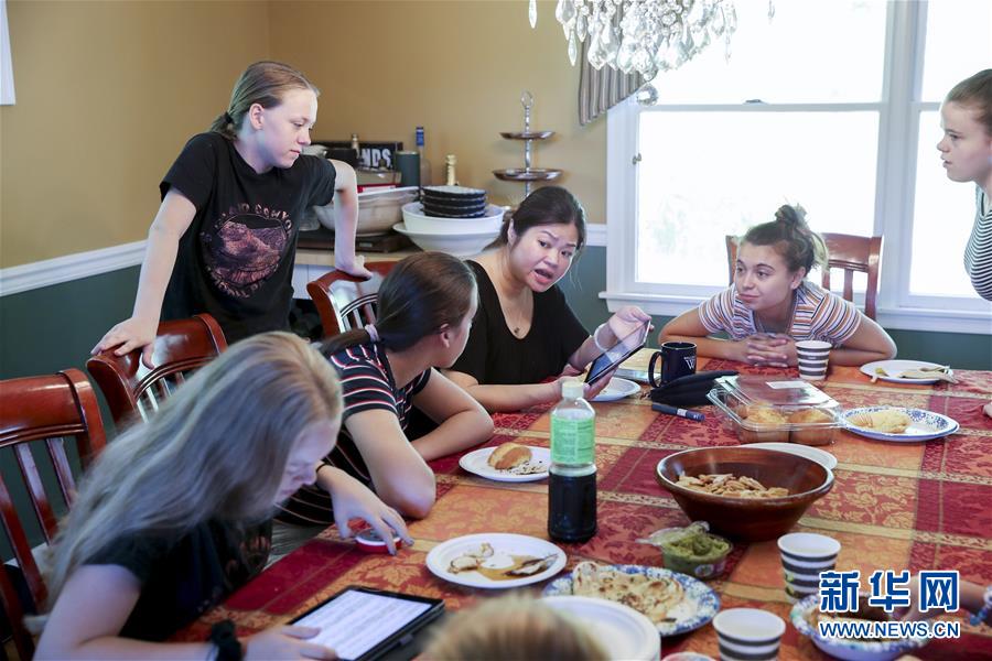 7월 13일 린•베라트 씨의 딸들이 미국 뉴저지주에 위치한 중국어 선생님 집에서 중국어 선생님(가운데)과 교류하는 모습 [사진 출처: 신화망]