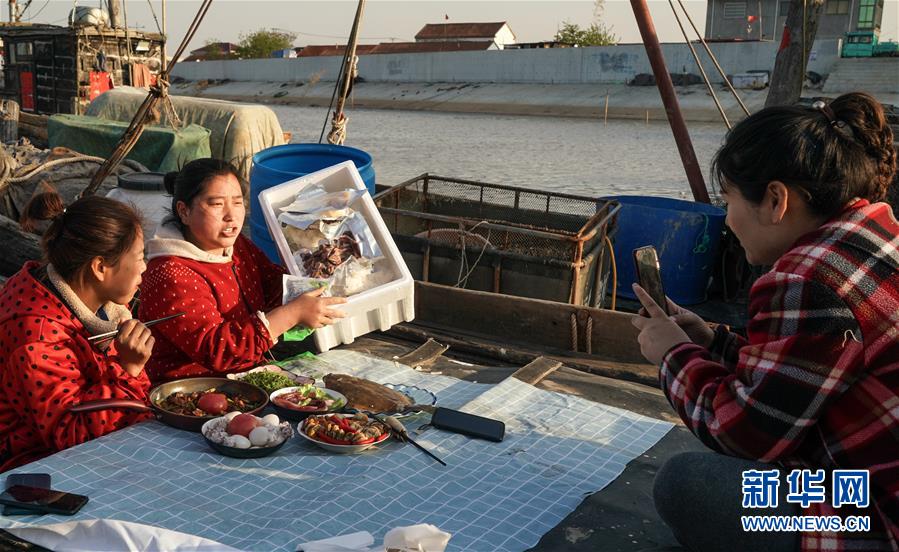 마화위(중간)가 해산물을 추천하고 있다. 그녀는 평소 돼지고기를 팔며 해산물 판매도 같이하고 있다. [4월 22일 촬영/사진 출처: 신화망] 