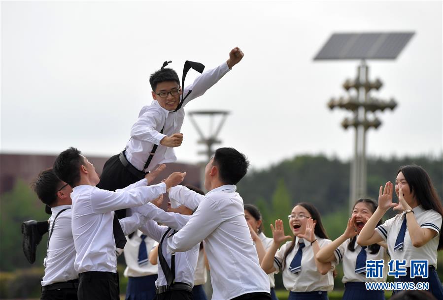 난창대학교 캠퍼스 안에서 학생들이 함께 환호성을 지르며 졸업 사진을 찍고 있다. [6월 10일 촬영/사진 출처: 신화망]
