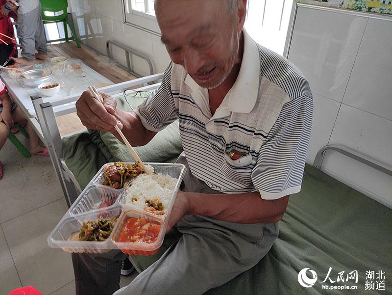70세의 우윈야오가 점심을 먹고 있다. [사진 출처: 인민망]