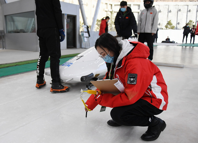 2월 20일, 옌칭 경기구역 국가 봅슬레이·루지 센터에서 직원이 빙판의 온도를 측정하고 있다. [사진 출처: 신화망]
