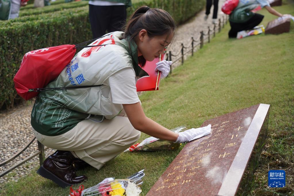 9월 30일 청년 자원봉사자들이 상하이 룽화열사능원에서 열사 묘비를 닦고 있다. [사진 출처: 신화사]