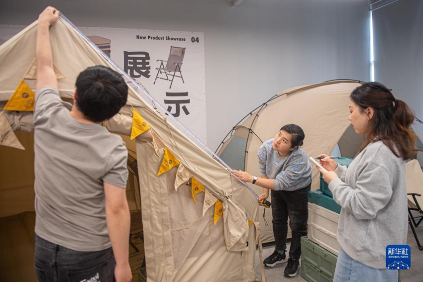 야외용품업체 제품연구개발팀 직원들이 텐트 샘플 관련 데이터를 집계하고 있다. [5월 18일 촬영/사진 출처: 신화사]