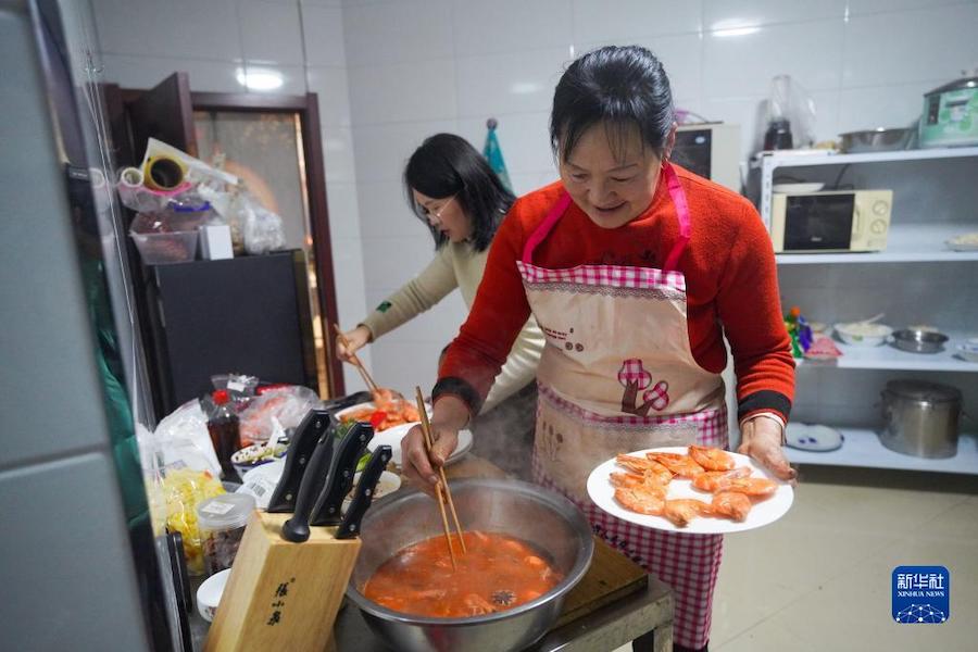장훙샤(오른족)가 부엌에서 손님을 위해 명절 음식을 준비하고 있다. [1월 21일 촬영/사진 출처: 신화사]