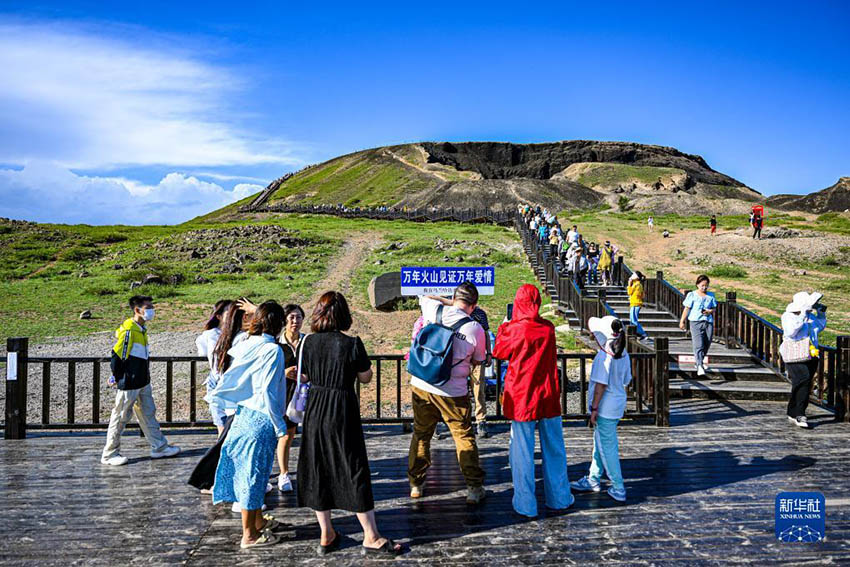 관광객들이 화산을 배경으로 기념사진을 찍는다. [8월 6일 촬영/사진 출처: 신화사]