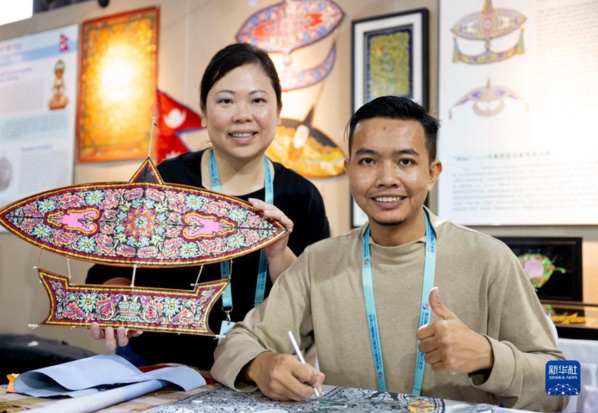 말레이시아에서 온 연 아티스트 루슬리(오른쪽)가 사업 파트너와 직접 디자인한 연을 선보이고 있다. [12월 9일 촬영/사진 출처: 신화사]
