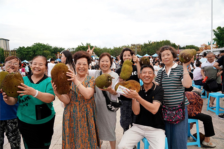 망시 제7회 문명과실 나눔 행사 현장, 시민과 관광객들이 받은 과일을 들고 기념사진을 찍는다. [사진 촬영: 양방칭]