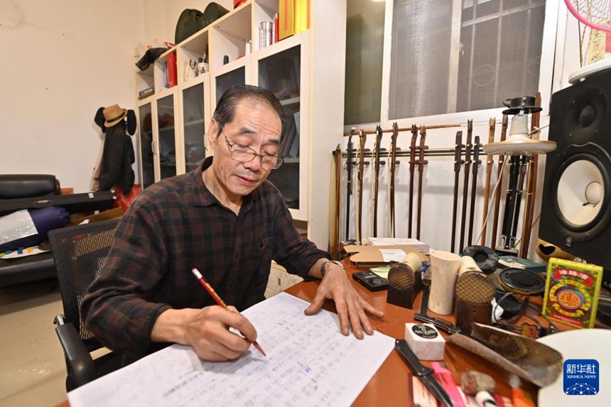 황이거가 자택에서 좡족 마골호 악보를 연구하고 있다. [10월 10일 촬영/사진 출처: 신화사]